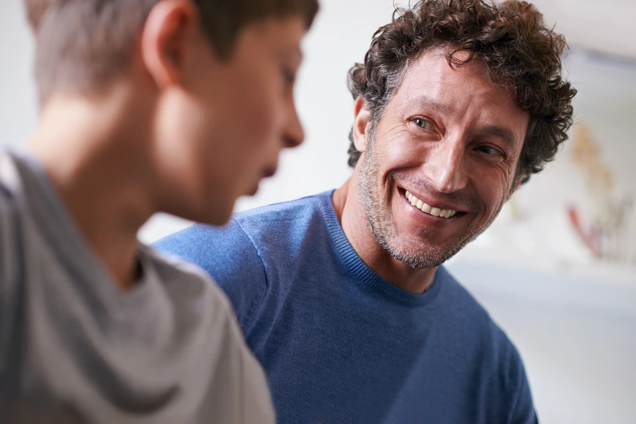 A father and son chatting together
